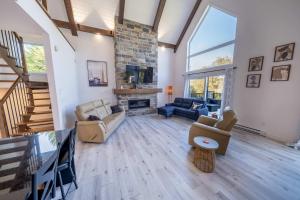 a living room with a couch and a fireplace at Spa - Chalet la Barque du Bonheur in Sainte-Germaine-du-Lac-Etchemin
