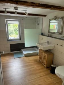 a bathroom with a sink and a toilet at Ferienwohnung im Hooptal in Negenborn +13 photos