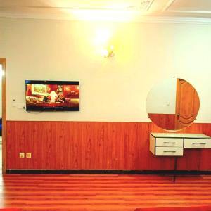 a room with a flat screen tv on a wall at Hospitality Hub in Islamabad