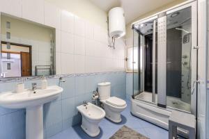 a bathroom with a sink and a toilet and a shower at Bright & Comfy 2BR Apartment by the Adriatic in Durrës +22 photos