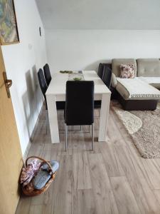 a living room with a white table and a couch at Apartmani LIDER Visoko in Visoko