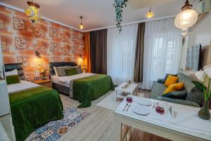 a hotel room with two beds and a couch at Taksim Nil Suite in Istanbul +193 photos