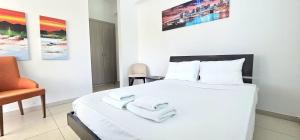 a bedroom with a white bed with towels on it at Agia Thekla bungalow with pool in Ayia Napa +19 photos