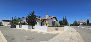 a house sitting on the side of a street at Agia Thekla bungalow with pool in Ayia Napa