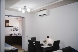 a kitchen and dining room with a table and chairs at The Boutique Apartment in Parma