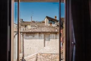 a view of a building from a window at The Boutique Apartment in Parma