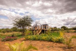 a house with a glass dome in a field at Nanare Chalets Amboseli in Poka