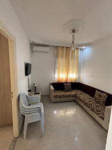 a living room with a couch and a chair at Dar zman in Kelibia +12 photos