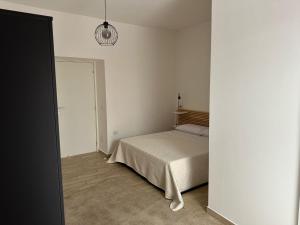a bedroom with a bed and a pendant light at Mama House in Naples +17 photos