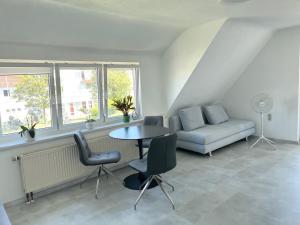 a living room with a table and a couch at Apartment TwentyTwo in FDH