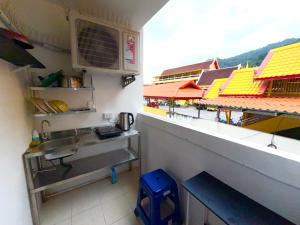 a kitchen with a counter and a sink in a room at Patong Canal Villa R201 in Patong Beach