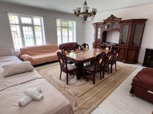 a living room with a dining room table and chairs at Magnificent view with 6 beds in Gabala