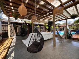 a patio with a hammock and a pool at Flat do Oscar na Villela Home Stay Lago Sul DF in Brasília