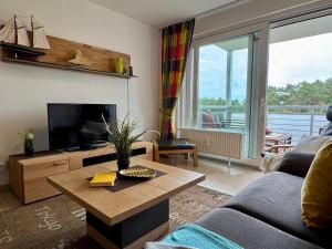 Μια τηλεόραση ή/και κέντρο ψυχαγωγίας στο Käptn Brass Appartement 14 Meeresbrise