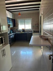 a large kitchen with a table in the middle of it at Beach palace 1 between sea pool and city center in Mohammedia