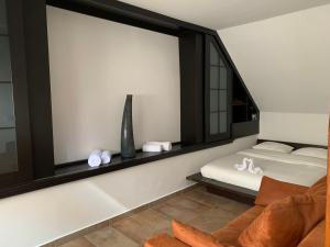 a room with a bed and a chair and a window at Near Everything Apartment in Győr