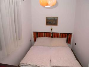 A bed or beds in a room at Holiday home in Balatonmariafürdo 19576