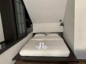 a bed in a room with a white blanket at Near Everything Apartment in Győr