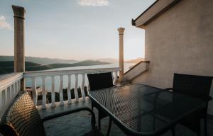 a table and chairs on a balcony with a view at Apartment Sunset Cove in Neum