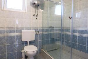 a bathroom with a toilet and a glass shower at Apartment Sunset Cove in Neum +5 photos