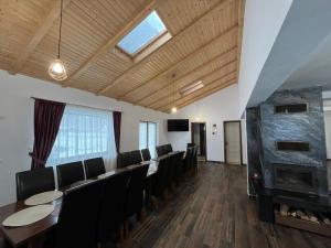 a conference room with a long table and chairs at Hillside Chalet in Buzoel