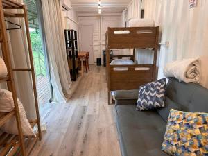 a living room with a couch and bunk beds at Flat do Burle Marx Villela Home Stay Lago Sul DF in Brasília