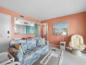 a living room with a couch and a chair at Ocean Breeze - Stunning Views - Oceanfront - 3rd floor - You deserve a beach vacation! condo in Carolina Beach