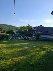 a field with a barn and a building at La Foisor in Vărbilău +42 photos
