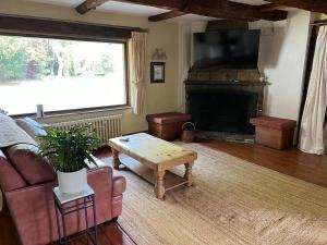 a living room with a couch and a fireplace at Heron House in Warwick