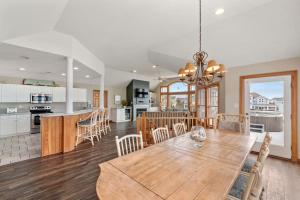 a dining room and kitchen with a table and chairs at White Dolphin Left in Corolla