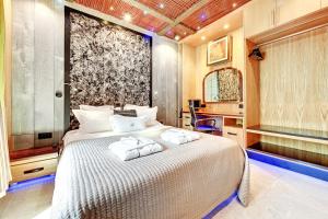 a bedroom with a bed with towels on it at Mała Anglia - Boutique Apartments & SPA in Sopot