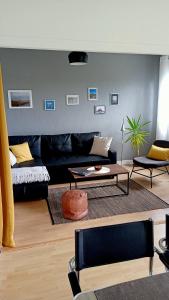 a living room with a couch and a table at Le Petit Mouton in Pontorson