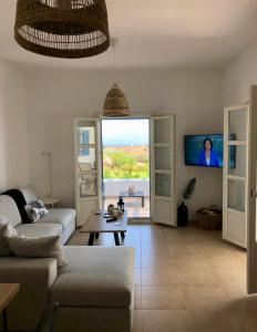 a living room with a couch and a table at Eliza & Mike's Villas Paros in Kampos Paros