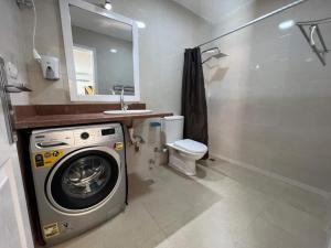 a bathroom with a washing machine and a toilet at Family Chalet Pool & Aqua-Park Access in Sharm El Sheikh in Sharm El Sheikh