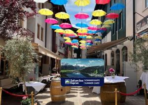 a bunch of umbrellas hanging over a street at Appartements Cella Central in Zell am See