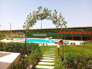 a swimming pool with a sign that at Family Chalet Pool & Aqua-Park Access in Sharm El Sheikh in Sharm El Sheikh