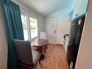a kitchen with a table and a chair and a window at Family Chalet Pool & Aqua-Park Access in Sharm El Sheikh in Sharm El Sheikh