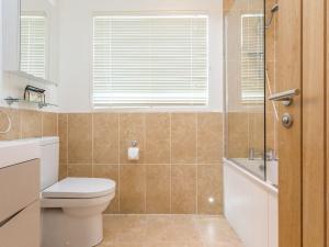 a bathroom with a toilet and a sink and a shower at 2 Tree Tops in Looe +35 photos