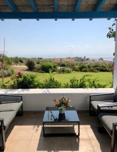 a living room with a large window and a table at Eliza & Mike's Villas Paros in Kampos Paros +36 photos