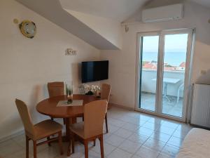 a dining room with a table and a view of the ocean at Apartments Borovina in Bol