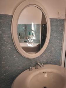 a bathroom with a sink and a mirror at Château Maranne in Parthenay