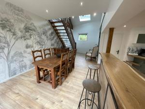 a dining room with a wooden table and chairs at Cézembre in La Houssière