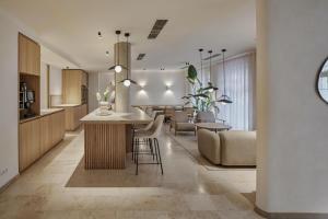 a kitchen and living room with a table and chairs at ADELANTE Boutique Hotel in Berlin