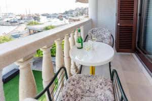 a white table and chairs on a balcony with a view at Villa Tramontana in Krilo
