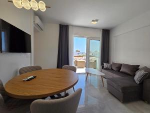 a living room with a table and a couch at Punta Mare Hotel in Karpathos Town