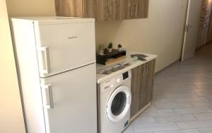 a kitchen with a refrigerator and a washing machine at Pansini Ruggiero's Rooms in Naples