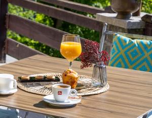 a glass of orange juice and a cup of coffee on a table at Roberto Hotel in Sinaia