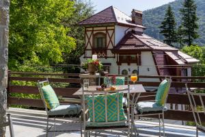 a table and chairs in front of a house at Roberto Hotel in Sinaia