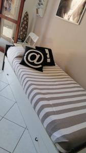 a bed with a football jersey on top of it at Casa Maestrale in Villasimius