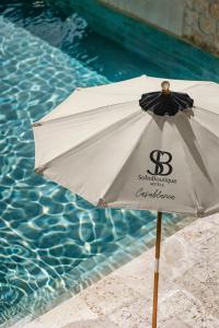 a white umbrella sitting next to a swimming pool at Soho Boutique Casablanca in Casablanca